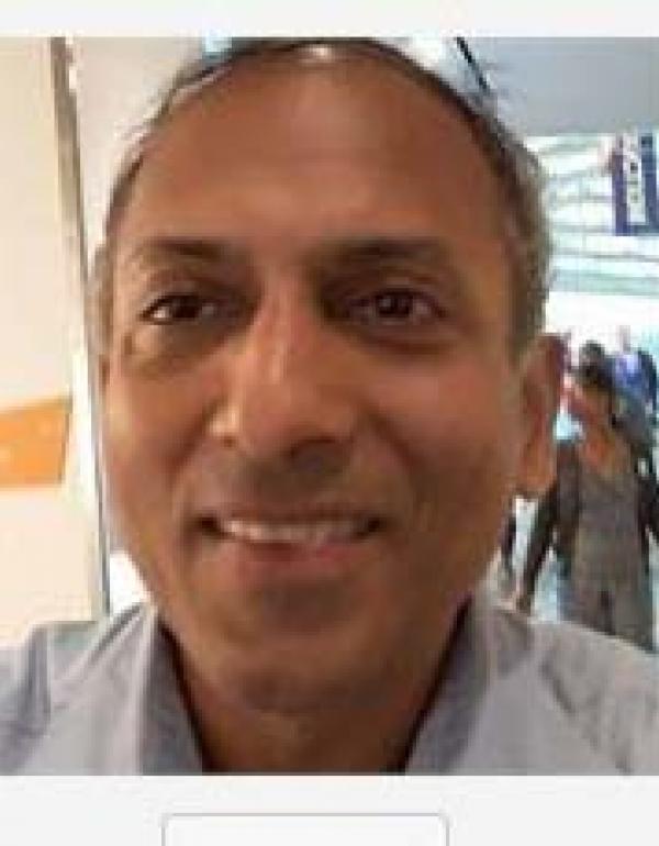 Mr. Vijay wearing a blue button down shirt