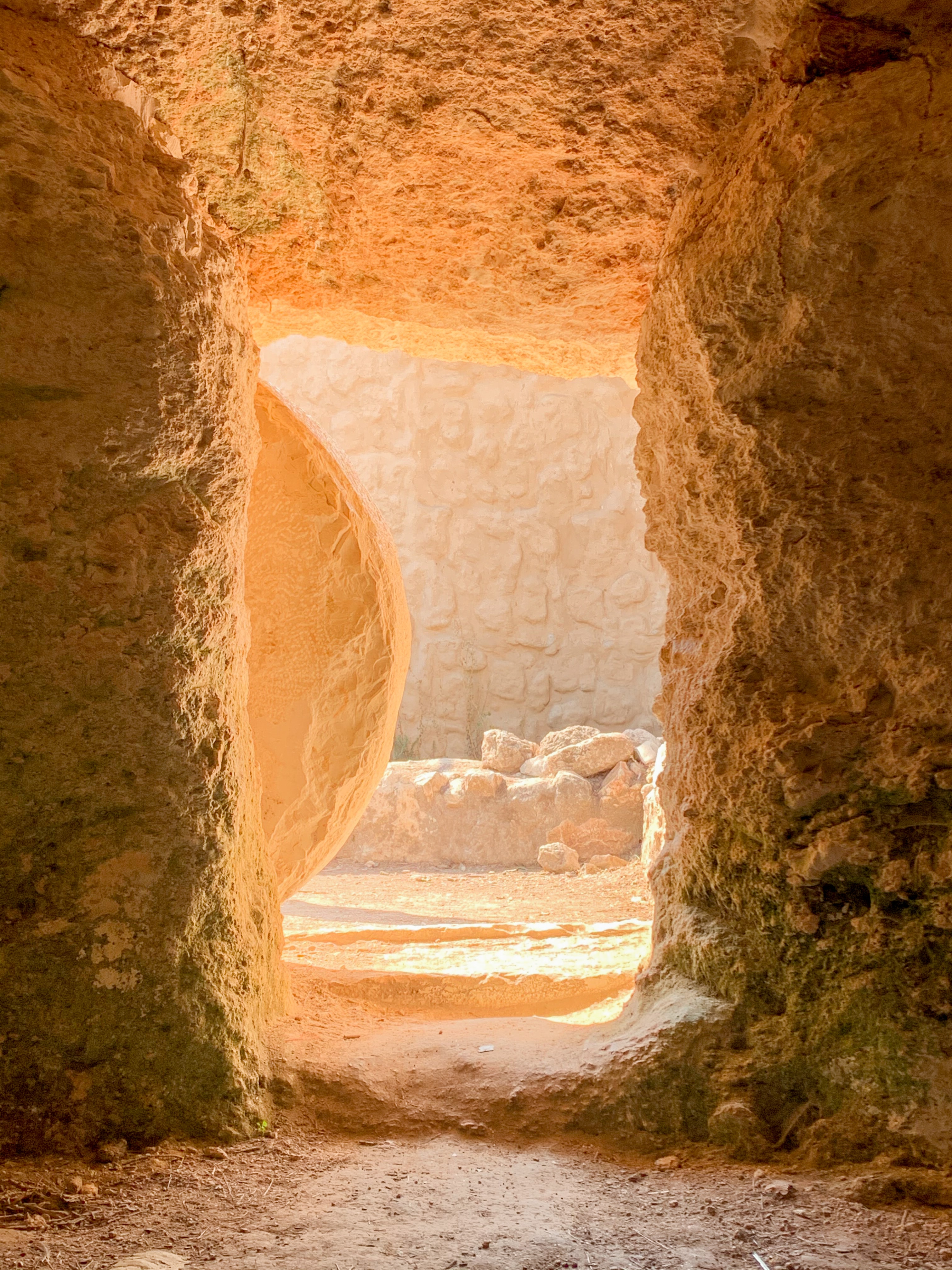 Inside the Garden Tomb of Jesus in Israel with round stone partially rolled back