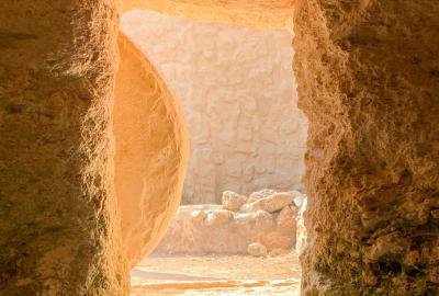 Inside the Garden Tomb of Jesus in Israel with round stone partially rolled back